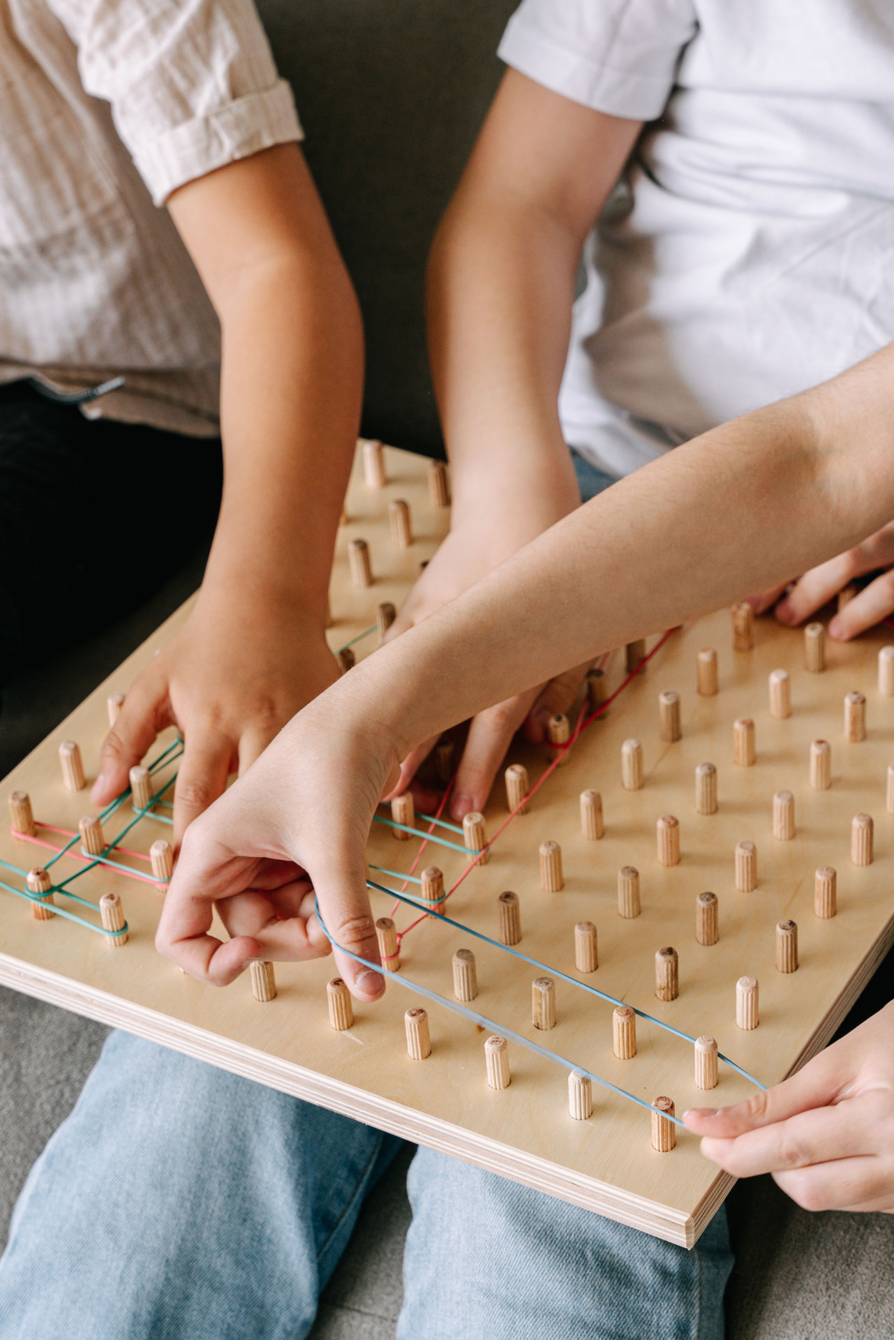 Therapist and child working together on a pegboard activity