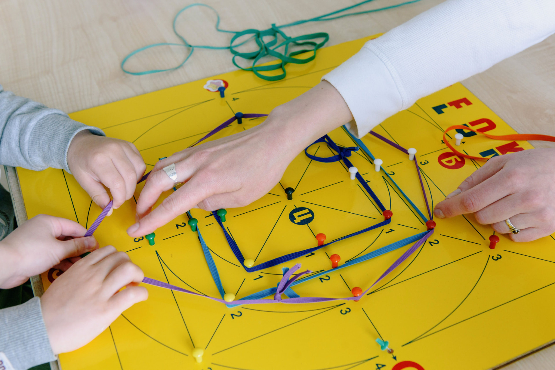 Therapist and teenager working together on a problem-solving activity board